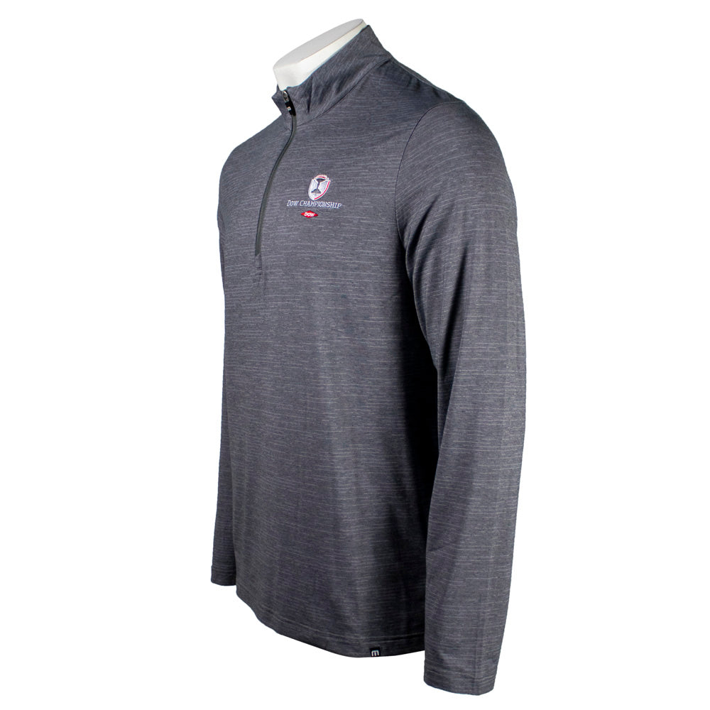 Side of a gray long-sleeve half-zip shirt with a logo on the left chest. 
